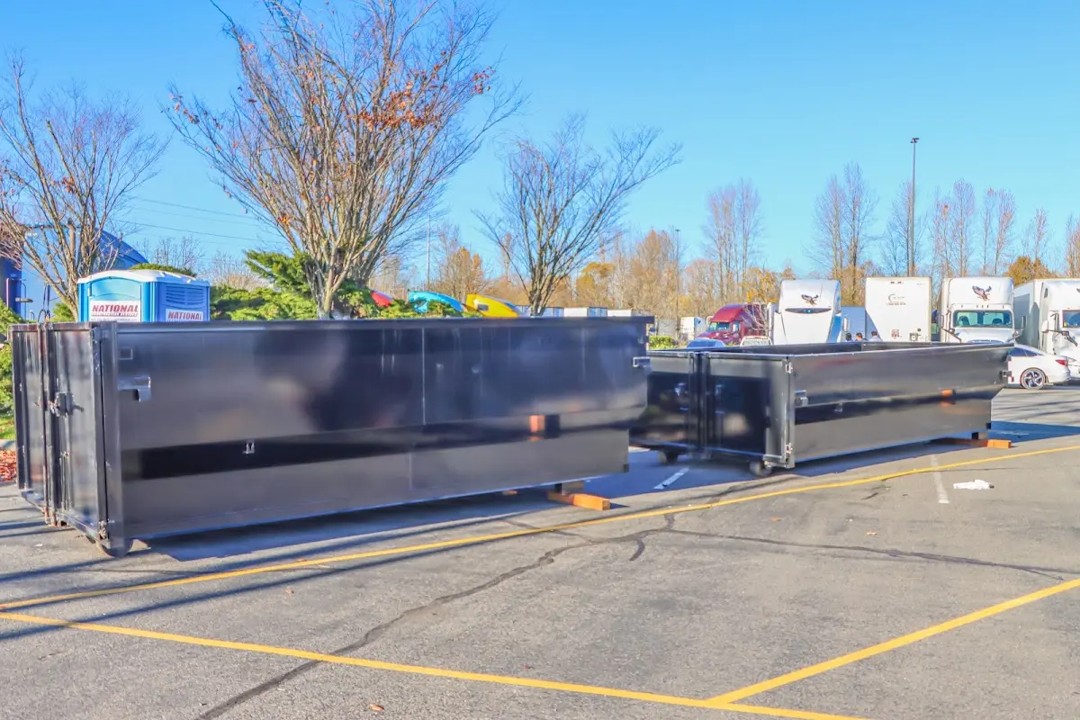 Professional dumpster rental service with roll-off container on residential driveway in Cedar Lake